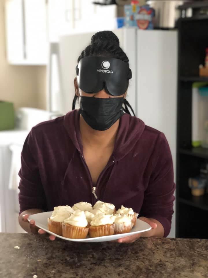 Hope Williams holds a plate of cupcakes.